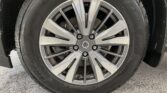 Close-up of a car wheel with a multi-spoke alloy rim and Goodyear tire, Nissan center cap visible in the hub area, the wheel on a vehicle stance.