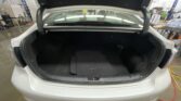 Open trunk of a silver sedan in a workshop, showing the empty cargo area and a branded floor mat that reads SOLARA.