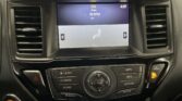 Infotainment screen in a car showing FM radio at 94.9 with genre 'Oldies' and the time 4:01, flanked by left/right arrows and a seated icon graphic below. A climate control panel sits beneath the screen.
