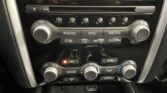 Car stereo console with radio controls, six preset buttons, and knobs labeled VOL and TUNE/FOLDER (center stack)