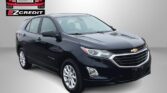 Black Chevrolet Equinox SUV at Easton Motors EZ Credit dealership with logo in background and 'APPLY, ARRIVE & DRIVE!' slogan.
