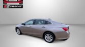 Beige four-door sedan posed in a neutral backdrop with Easton Motors EZCredit logo and the slogan 'APPLY, ARRIVE & DRIVE!'.