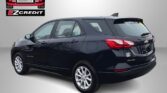 Rear-quarter view of a black Chevrolet Equinox SUV with Easton Motors EZ Credit branding in the corner and a promotional 'Apply, Arrive & Drive!' slogan at the bottom