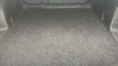 Dark car trunk interior with a horizontal bar spanning the rear cargo area.