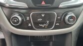 Center console climate control: hazard triangle button above, with various defrost and airflow buttons below; left knob adjusts fan speed, right knob sets temperature.