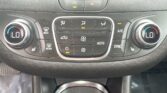 Dual-zone car climate control panel with left and right dials set to low temperature; central buttons control defrost, airflow, recirculation, AUTO, A/C, and SYNC.