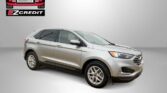 Silver SUV displayed on a neutral backdrop with Easton Motors EZCredit logo; bottom text reads 'APPLY, ARRIVE & DRIVE'.