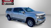 Blue Chevrolet Silverado pickup beside an EZCredit logo on a gray background, with the phrase 'APPLY, ARRIVE & DRIVE!' in red at the bottom.