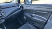 Interior view of a car passenger side with dashboard, center console controls, and pattern cloth seat.