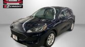 Black Ford SUV in a showroom with an Easton Motors EZCredit logo on the wall and the slogan 'Apply, Arrive & Drive' visible.