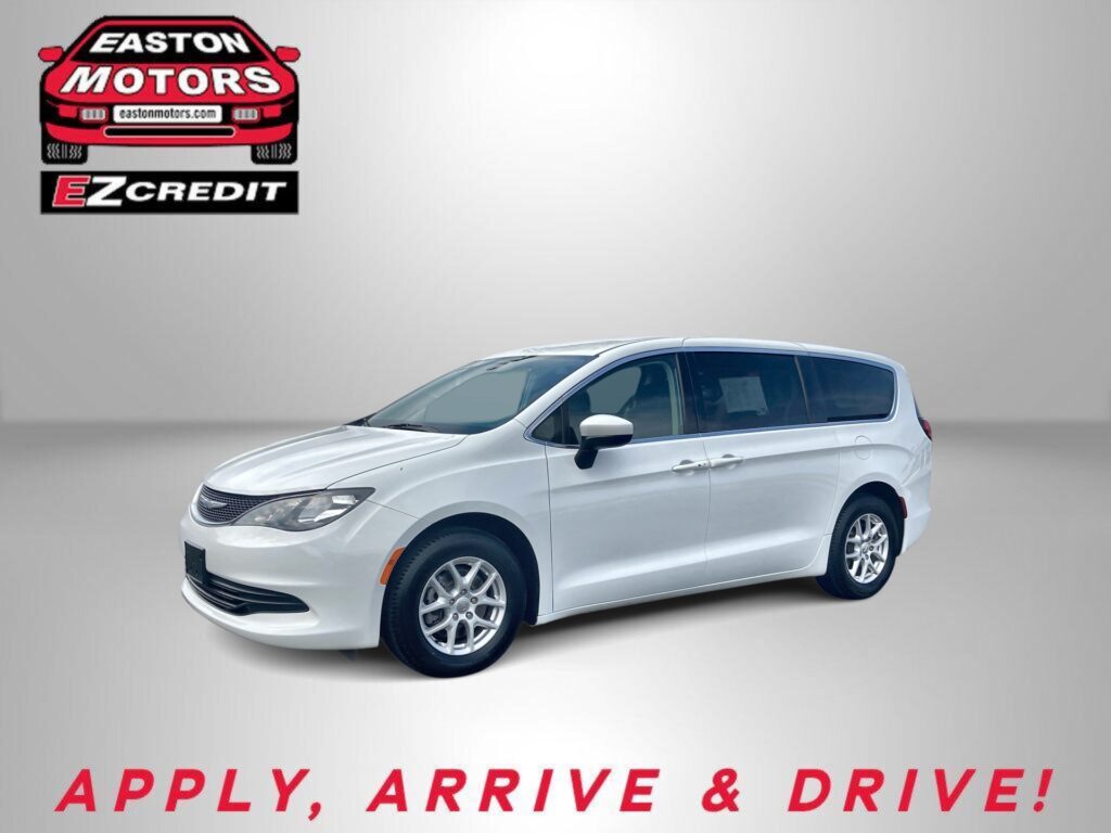 White car in a studio setting with a red Easton Motors logo on the wall and the slogan 'APPLY, ARRIVE & DRIVE!' in red at the bottom