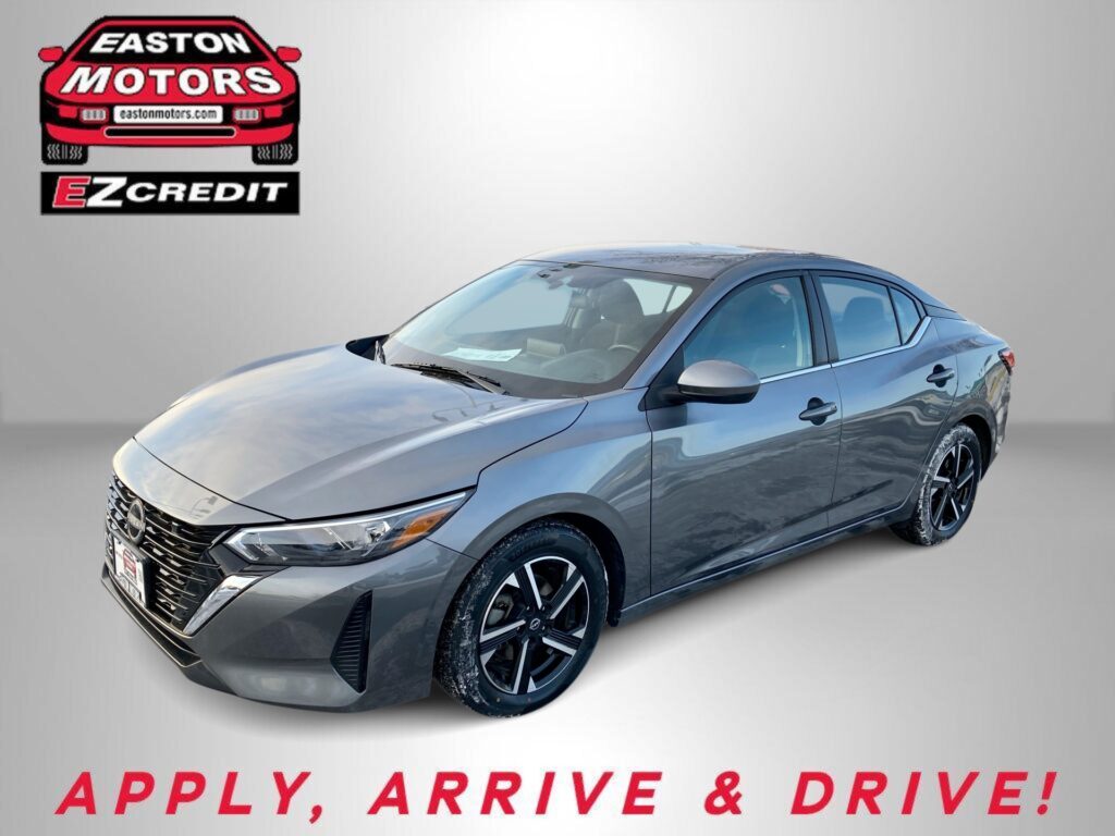 Gray sedan parked against a light backdrop with an Easton Motors EZ Credit logo in the top-left corner and bold red text at the bottom reading 'APPLY, ARRIVE & DRIVE!'