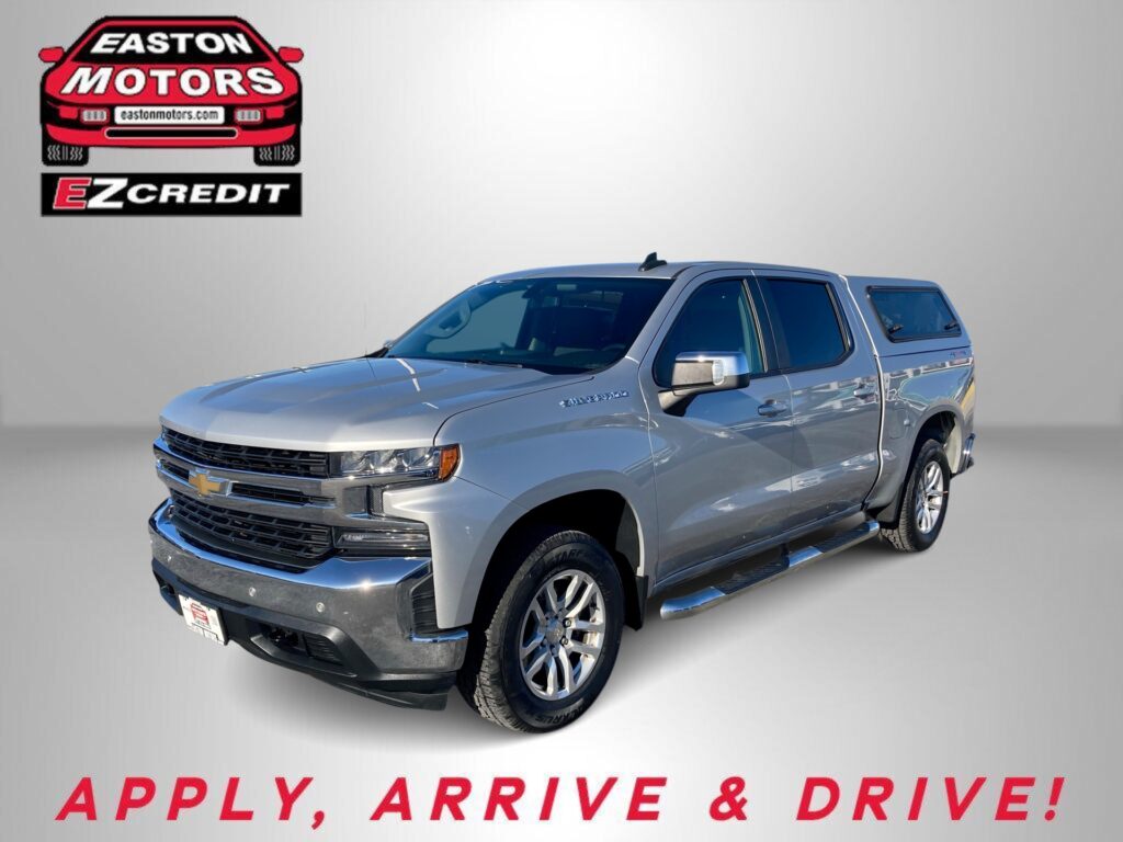 Silver Chevrolet pickup truck with EZ Credit logo in the top-left corner and red 'APPLY, ARRIVE & DRIVE!' slogan at the bottom.