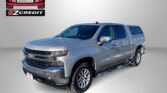 Silver Chevrolet pickup truck with EZ Credit logo in the top-left corner and red 'APPLY, ARRIVE & DRIVE!' slogan at the bottom.