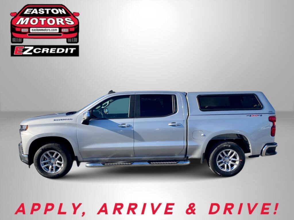 Silver pickup truck against a gray backdrop with Easton Motors EZ Credit logo; bottom text reads 'APPLY, ARRIVE & DRIVE!'