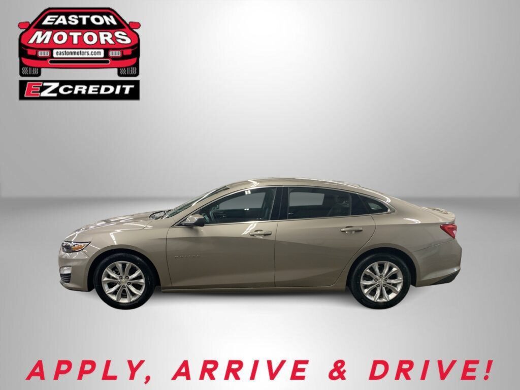Beige sedan parked in a studio with an Easton Motors logo in the upper left and a red 'APPLY, ARRIVE & DRIVE!' slogan along the bottom.