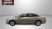 Beige sedan parked in a studio with an Easton Motors logo in the upper left and a red 'APPLY, ARRIVE & DRIVE!' slogan along the bottom.