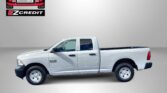 White RAM 1500 pickup on a gray banner with EZCredit logo in the top-left and the text 'APPLY, ARRIVE & DRIVE!'