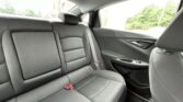 Rear seat area of a dark gray car interior with three seats and visible seat belts.