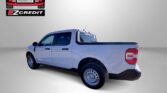 White pickup truck featured in an Easton Motors ad with EZCredit branding and the slogan 'APPLY, ARRIVE & DRIVE!'
