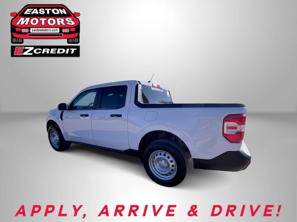 White pickup truck featured in an Easton Motors ad with EZCredit branding and the slogan 'APPLY, ARRIVE & DRIVE!'