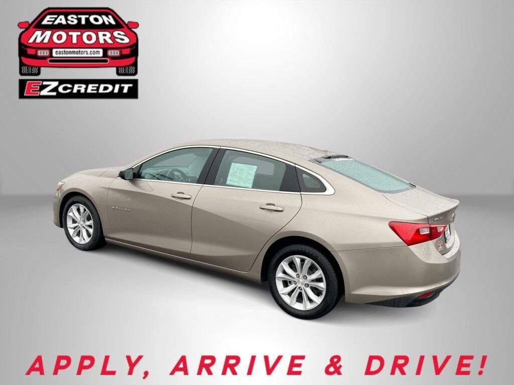 Beige four-door sedan on a gray studio backdrop, EZCredit logo in the top-left and the slogan 'APPLY, ARRIVE & DRIVE!' along the bottom.