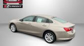 Beige four-door sedan on a gray studio backdrop, EZCredit logo in the top-left and the slogan 'APPLY, ARRIVE & DRIVE!' along the bottom.