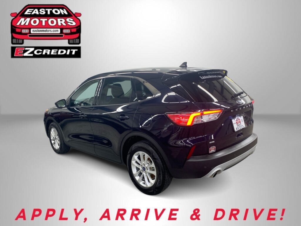 Rear three-quarter view of a black SUV in a studio with Easton Motors EZ Credit logo in the upper left and 'APPLY, ARRIVE & DRIVE!' text at the bottom.