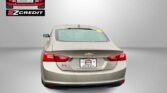 Beige Chevrolet rear view with Easton Motors logo in the top left and promotional text 'APPLY, ARRIVE & DRIVE' at the bottom.