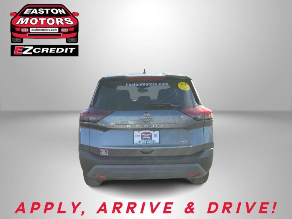 Rear view of a Nissan Rogue with Easton Motors branding on the back window and 'APPLY, ARRIVE & DRIVE!' slogan at the bottom.