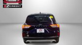 Rear view of a dark SUV with Easton Motors branding on the back window and a yellow smiley sticker; ad text below reads 'APPLY, ARRIVE & DRIVE!'