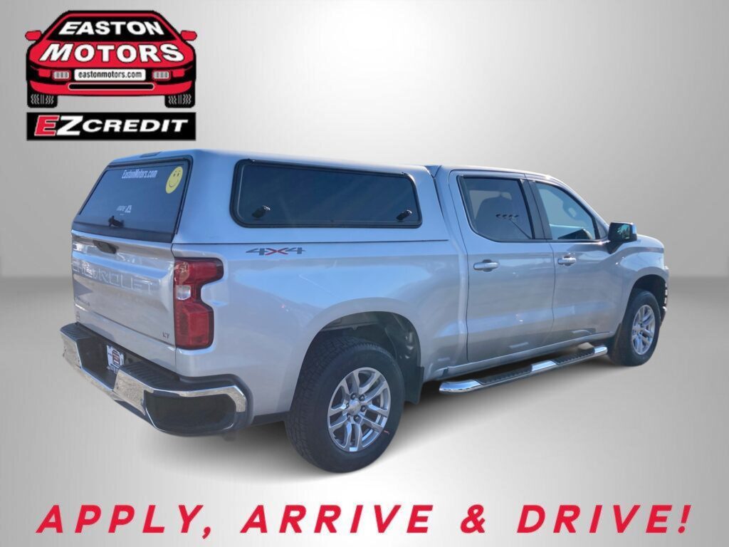 Silver pickup with blue canopy; Easton Motors and EZCredit logos on a gray background.