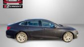 Dark blue sedan parked in front of a gray gradient background with Easton Motors and EZCredit logos above it.
