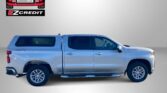 Blue pickup truck with EZ Credit branding on a gray background, advertisement text reading 'APPLY, ARRIVE & DRIVE!'