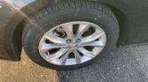 Close-up of a black car tire and silver alloy wheel, Chevrolet emblem at the center.