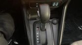 Automatic gear selector in center console with P R N D S indicators, cup holder, and 12V socket nearby