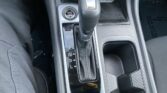 Automatic gear selector in the center console with a surrounding glossy panel and a Start/Stop engine button nearby.