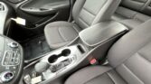 Front interior of a car showing driver and front passenger seats, center console, cupholders, and gear shifter visible.