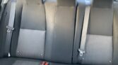 Rear car seats with three seating positions and three seat belts in black fabric interior