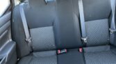 Rear car seat view: three-seat bench with patterned fabric and three buckle-fastened seat belts