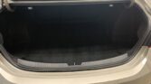 Open car trunk with empty cargo area in a silver vehicle, showing black interior lining and the trunk lip at the bottom edge