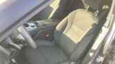Interior of a car shown from the driver's side: front seats, center console with cup holder, and steering wheel visible.