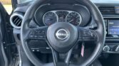 Steering wheel in a Nissan with the tachometer left, speedometer right, and a digital display in the center.