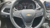 Steering wheel with Chevrolet emblem, dashboard gauges visible including speedometer and tachometer, center display showing trip data inside a car interior.