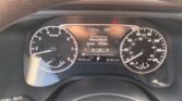 Driver’s view of the instrument cluster: tachometer on left, speedometer on right, with a central display showing fuel economy data and average MPG.