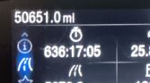 Vehicle dashboard displaying odometer 50,651.0 miles and a trip distance of 636.17 miles with info icons on the left side.