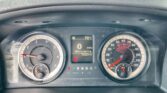 Close-up of a car dashboard: digital display shows 0 MPH, 72,924 miles, N gear, and PRND indicators with two large gauges on either side (speedometer and tachometer).