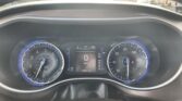 View of a car dashboard from the driver's seat, with blue-lit analog gauges and a central digital display showing 0 MPH and 107,801 miles
