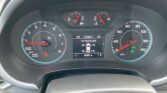 Car dashboard instrument cluster with tachometer on left, speedometer on right, and center digital display showing tire pressure and mileage.