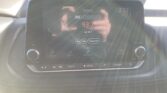 In-car touchscreen displaying FM radio tuning to 93.7 (LaZ 93.7, country music) with time 2:52 visible and playback controls below.